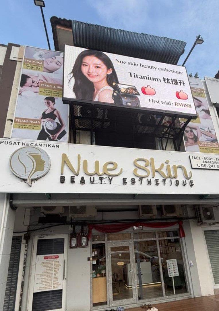 Nue Skin Beauty Esthetique storefront with gold signage, Titanium promotion billboard and treatment posters at No 55 Laluan Pinji Seni 4, Taman Pinji Seni, Ipoh Perak — Nue Skin Beauty Esthetique